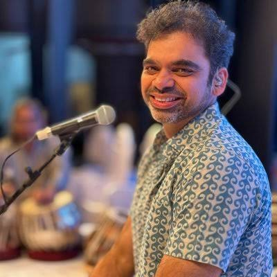 Rahul Deshpande mid-performance at the microphone