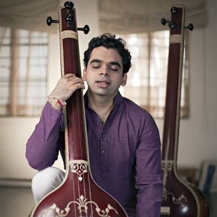 Rahul Deshpande with a tanpura, eyes closed mid-raga